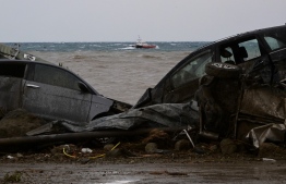 Damaged cars are seen in the sea in the southern Ischia island on November 26, 2022, following heavy rains that sparked a landslide. - Italy's interior minister said there had been no confirmed deaths in a landslide on November 26, 2022 on the island of Ischia, despite earlier reports of eight killed. (Photo by Ansa / AFP) / 