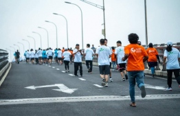 People taking part in Maldives China Friendship Run at the Sinamale' Bridge to mark the 50th anniversary of the establishment of political relations between Maldives and China. -- Photo: Chinese Embassy
