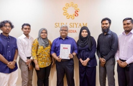 Sun Siyam Media Group COO Mohamed Asif (C) with employees of the Media -- Photo: Sun Siyam Media