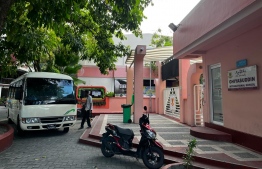 The school bus waiting to pick up students Infront of the school gates