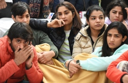 (L-3R) Indian wrestlers Bajrang Punia, Anshu Malik, Vinesh Phogat and Sakshi Malik along with others wrestlers take part in an ongoing protest against the Wrestling Federation of India (WFI), in New Delhi on January 19, 2023, following allegations of sexual harassment to athletes by members of the WFI. - Triple Commonwealth Games gold medallist Vinesh Phogat, one of India's most decorated women wrestlers, has accused her federation chief and several coaches of sexually harassing multiple athletes. -- Photo: Sajjad Husain / AFP