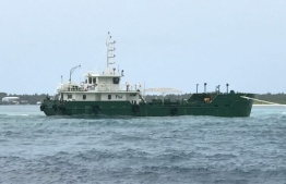 A barge which ran aground in a Kaafu atoll reef earlier -- Photo: MNDF