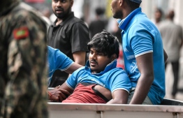 Victim who fell off a building in Malé being loaded onto a pickup to be taken to the hospital -- Photo: Fayaz Moosa
