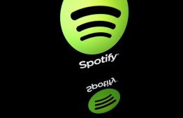 (FILES) This file photo illustration taken on April 19, 2018 in Paris shows the logo of online streaming music service Spotify displayed on a tablet screen. - Music streaming giant Spotify on January 31, 2023 reported a total of 205 million paying subscribers at the end of 2022, beating expectations, but its losses deepened. -- Photo: Lionel Bonventure / AFP