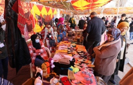 Visitors are pictured at a market during the opening of the Ghadames festival in the Libyan town of Ghadames, a desert oasis some 650 kilometres (400 miles) southwest of the capital Tripoli on February 1, 2023. -- Photo: Mahmud Turkia / AFP