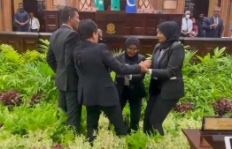 Female security trying to remove two male parliament members from the parliament chambers: The scene of female security personnel attempting to remove MP's have been heavily crticized