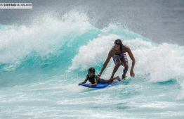 Kayan surfing with his father, veteran surfer Abdulla Areef ("Fuku"). Photo: Mohamed Shareef