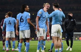 (From L) Manchester City's English midfielder Kalvin Phillips, Manchester City's Dutch defender Nathan Ake, Manchester City's Norwegian striker Erling Haaland and Manchester City's English midfielder Jack Grealish celebrate at the end of the English Premier League football match between Arsenal and Manchester City at the Emirates Stadium in London on February 15, 2023. - Manchester City won 3 - 1 against Arsenal. -- Photo: Glyn Kirk / AFP