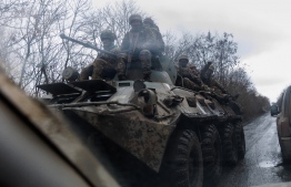 Ukrainian servicemen ride on an APC (armored personnel carrier) on a road in the Donetsk region on February 28, 2023, amid the Russian invasion of Ukraine. -- Photo: Anatolii Stepanov / AFP