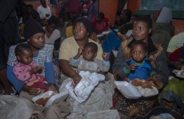 Mudslide victims receive meals at Chilobwe township’s Naotcha Primary school camp in Blantyre on March 14, 2023. The death toll from Cyclone Freddy in Malawi and Mozambique passed 200 on March 14, 2023 after the record-breaking storm triggered floods and landslips in its second strike on Africa in less than three weeks. -- Photo: Amos Gumulira / AFP