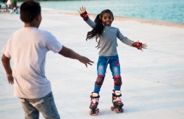 A child in Dharanboodhoo roller-skating; the reclaimed land near the harbour has become an area to spend recreational time with for Dharanboodhoo locals  -- Photo: Vishau Zareer / Mihaaru