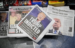 Newspaper front pages with former US President Donald Trump, are displayed at a news stand in New York on March 31, 2023. - A New York grand jury has voted to indict former US president Donald Trump over hush money payments made to porn star Stormy Daniels ahead of the 2016 election, multiple US media reported on March 30, 2023. -- Photo: Ed Jones / AFP