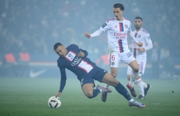 Paris Saint-Germain's French forward Kylian Mbappe and Lyon's French midfielder Maxence Caqueret fight for the ball during the French L1 football match between Paris Saint-Germain (PSG) and Olympique Lyonnais (OL) at The Parc des Princes Stadium in Paris on April 2, 2023. -- Photo: Franck Fife / AFP