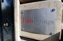 This photograph taken on August 8, 2011, shows the entrance of Fitch ratings agency in Paris. - Credit ratings agency Fitch downgraded France's debt worthiness a notch to "AA-" from "AA" on April 28, claiming the country's "fiscal metrics are weaker than peers". -- Photo: Miguel Medina / AFP