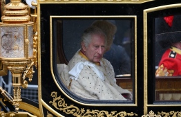 Britain's King Charles III and Britain's Camilla, Queen Consort ride in the Diamond Jubilee State Coach, during the 'King's Procession', a journey of two kilometres from Buckingham Palace to Westminster Abbey in central London on May 6, 2023, ahead of their coronations. - The set-piece coronation is the first in Britain in 70 years, and only the second in history to be televised. Charles will be the 40th reigning monarch to be crowned at the central London church since King William I in 1066. Outside the UK, he is also king of 14 other Commonwealth countries, including Australia, Canada and New Zealand. Camilla, his second wife, will be crowned queen alongside him and be known as Queen Camilla after the ceremony. -- Photo: Glyn KIRK / AFP