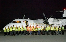 Staff of Regional Airports stand in front of the night landing test flight-- Photo: RACL