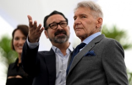 US director James Mangold (L) and US actor Harrison Ford pose during a photocall for the film "Indiana Jones and the Dial of Destiny" at the 76th edition of the Cannes Film Festival in Cannes, southern France, on May 19, 2023. -- Photo: Patricia De Melo Moreira / AFP