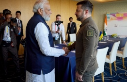 This handout photograph taken and released by the Ukrainian Presidential Press Service on May 20, 2023, shows Ukraine's President Volodymyr Zelensky (R) shaking hands with India's Prime Minister Narendra Modi (L) in Hiroshima, on the second day of the G7 Summit Leaders' Meeting. Zelensky's surprise summit appearance -- he had been expected to appear by video call -- is his furthest foray from Kyiv since Russia's invasion began 15 months ago. -- Photo by Handout / Ukrainian Presidential Press Service / AFP