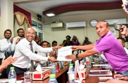 (FILE) New political party registration form handed over to Elections Commission Vice President Ismail Habeeb (R) on May 21, 2023: the membership registration forms will be submitted on Thursday, June 1, 2023 to EC -- Photo: Fayaaz Moosa