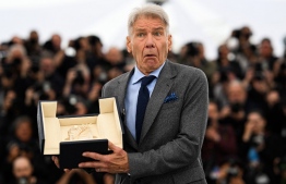 US actor Harrison Ford poses with his Honorary Palme d'Or during a photocall for the film "Indiana Jones and the Dial of Destiny" at the 76th edition of the Cannes Film Festival in Cannes, southern France, on May 19, 2023. -- Photo: Patricia De Melo Moreira / AFP