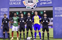 Nassr's Portuguese forward and team captain Cristiano Ronaldo (2nd R) and Ettifaq's Saudi midfielder and team captain Ali Hazazi (2nd L) pose for a picture with the referee team ahead of the Saudi Pro League football match between Al-Nassr and Al-Ettifaq at the Prince Mohammed Bin Fahd Stadium in Dammam on May 27, 2023. -- Photo: AFP