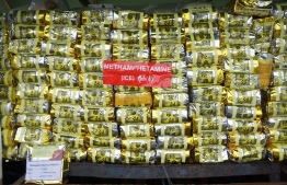(FILES) A stack of illegal methamphetamine is pictured before being set on fire during a destruction ceremony to mark the United Nations' "International Day against Drug Abuse and Illicit Trafficking" in Yangon on June 26, 2021. Asian drug trafficking networks are increasingly using sea routes to smuggle methamphetamines out of Myanmar and ramping up ketamine production as they seek to expand their business, the UN warned on June 2, 2023. (Photo by AFP)