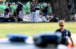 French forensic police officers work at the scene of a stabbing attack in the 'Jardins de l'Europe' park in Annecy, in the French Alps, on June 8, 2023. A Syrian refugee suspected of stabbing six people in the French Alpine town of Annecy on Thursday did not appear to have a "terrorist motive", the local prosecutor told reporters. Prosecutor Line Bonnet-Mathis said that of the four children injured in the assault, one was aged just 22 months, two were two-year-olds, and the eldest was three. (Photo by OLIVIER CHASSIGNOLE / AFP)
