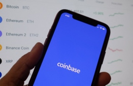 (FILES) This illustration file photo shows the Coinbase logo on a smartphone in Los Angeles on April 13, 2021. US securities regulators sued Coinbase on June 6, 2023, alleging that the cryptocurrency platform's failure to register as a securities exchange venue exposed investors to risk. The complaint comes on the heels of Securities and Exchange Commission charges filed June 5 against cryptocurrency exchange Binance and founder Changpeng Zhao for numerous securities law violations, including running an unregistered national securities exchange. -- Photo: Chris Delmas / AFP