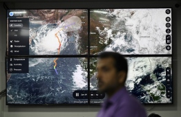 An official of the National Disaster Management Authority (NDMA) stands in front of a TV screen displaying satellite images of cyclone Biparjoy at the NDMA monitoring room in Islamabad on June 14, 2023. More than 100,000 people have been evacuated from the path of a fierce cyclone heading towards India and Pakistan, with forecasters warning on June 14 it could devastate homes and tear down power lines. -- Photo: Farooq Naeem / AFP
