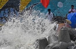 People stand by the sea as High tides crashes, in Mumbai on June 14, 2023. More than 40,000 people have been evacuated across India and Pakistan as a cyclone approaches their coast, officials said on June 13, with gales of up to 150 kilometres per hour predicted. -- Photo: Punit Paranjipe / AFP