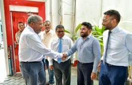 JP's Leader Qasim Ibrahim (L) shakes hands with his Spokesperson Abdulla Ameen at a JP political event on Thursday, June 15 --