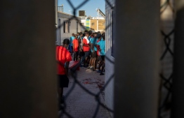 (FILES) Migrants queue in a temporary centre for migrants and asylum seekers on June 25, 2022 in Melilla, a day after at least 23 African migrants died in a bid by around 2000 people, mostly sub-Saharan African, to force their way into the northern Morocco Spanish enclave. Spain on June 24, 2023 marks the first anniversary of the deaths of at least 23 African migrants during an attempt to cross into it's North African enclave of Melilla from Morocco. -- Photo: Fadel Senna / AFP
