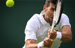 Serbia's Novak Djokovic returns the ball to Argentina's Pedro Cachin during their men's singles tennis match on the first day of the 2023 Wimbledon Championships at The All England Tennis Club in Wimbledon, southwest London, on July 3, 2023. -- Photo: Daniel Leal / AFP