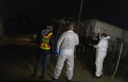 Members of the South African Police Service's (SAPS) forensic department take measurements about 300 metres away from a scene where people died from a gas leak at the Angelo informal settlement in Boksburg on July 6, 2023. At least 16 people, including children, have died after a gas leak at a South African informal settlement near Johannesburg, emergency services said on July 6, 2023, revising the death toll after some people were resuscitated.
Fire and emergency services received a call around 8 pm (1800 GMT) on July 5, 2023 about a gas explosion, but on arrival they discovered it was "a gas leakage from a cylinder" containing a "poisonous gas". -- Photo: Wikus de Wet / AFP