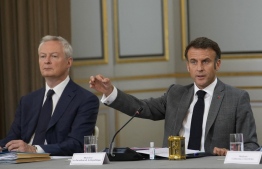 French President Emmanuel Macron (R) gestures as he speaks next to French Minister for the Economy and Finances Bruno Le Maire (L) during a cabinet meeting at the Elysee Palace in Paris on July 21, 2023. French presidency formalized French government reshuffle on July 20, 2023 with eight new members of a government which has 41 ministers in total. -- Photo: Christophe Ena / AFP