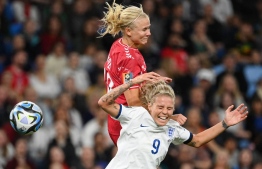 England's forward #09 Rachel Daly (down) and Denmark's forward #10 Pernille Harder (up) fight for the ball during the Australia and New Zealand 2023 Women's World Cup Group D football match between England and Denmark at Sydney Football Stadium in Sydney on July 28, 2023. (Photo by FRANCK FIFE / AFP)