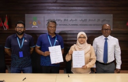 Director General of the planning ministry, Shaanaa Farooq, and MTCC CEO Adam Azim sign the agreement to implement a project -- Photo: Planning Ministry.