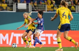 Japan's defender #17 Kiko Seike and Sweden's defender #02 Jonna Andersson fight for the ball during the Australia and New Zealand 2023 Women's World Cup quarter-final football match between Japan and Sweden at Eden Park in Auckland on August 11, 2023. -- Photo: Michael Bradley / AFP