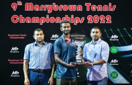 Sports Minister Mahloof awarding Faaih with his trophy after a tournament -- Photo: Fayaaz Moosa