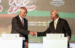 Current President Dr. Mohamed Muizzu (L) with former President Ibrahim Mohamed Solih (R) shakes hands at the presidential debate--