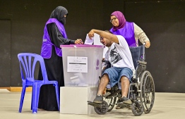 A person with special needs cast his vote-- Photo: Fayaz Moosa | Mihaaru