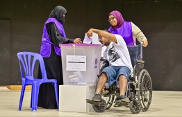 A disabled person casts his vote during the 2023 Presidential Election.-- Photo: Fayaz Moosa | Mihaaru