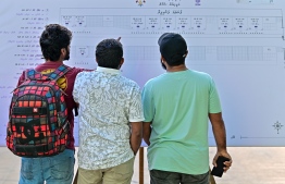 Voters clarify their voting booths at a polling station-- Photo Fayaz Moosa | Mihaaru