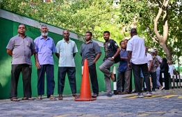Voters outside a polling station waiting for their turn to cast their votes-- Photo: Fayaz Moosa | Mihaaru