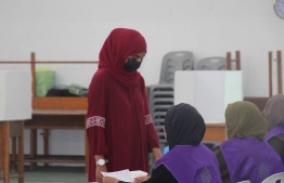 A voter at Raa atoll Meedhoo polling station clarifying information before casting her vote-- Photo: Ibrahim Rafhan | Mihaaru Reader