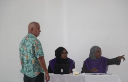 Election officials at Raa atoll Meedhoo voting center provides information to a voter-- Photo: Ibrahim Rafhan | Mihaaru Reader