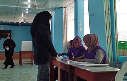 A voter near the polling station counter clarifying information before casting her vote-- Photo: Mihaaru Reader