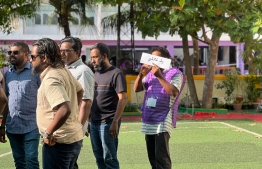 Polling official at Thaajuddin School informs closure of polling at the station-- Photo: Ifraz Ali | Mihaaru