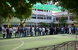 Voters lined up outside a polling station awaiting their turn to cast votes--