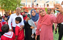 President Ibrahim Mohamed Solih takes a picture with teachers: the president has taken decisions to address grievance about salaries of nurses and teachers -- President's Office